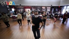 Walter Perez teaches a seniors dance class at senior centers in New York City. Older adults can socialize, stay fit, and enjoy the music during the coronavirus (COVID-19) pandemic, March 7, 2022. (Reuters Mike Segar)