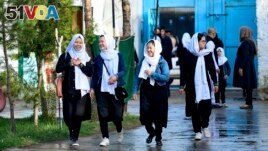 Girls arrive at their school in Kabul, Afghanistan, on March 23, 2022. But the Taliban said that high schools will not reopen for girls until a plan was drawn up to follow Islamic law and Afghan culture. (Photo by Ahmad SAHEL ARMAN / AFP)