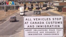 FILE - This April 16, 2001 file picture shows a sign written in both English and French as vehicles approach the Canadian-U.S. border at Stanstead, Quebec, Canada. (AP Photo/Jon-Pierre Lasseigne)