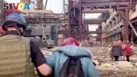 This frame taken from an undated video provided Sunday, May 1, 2022 by the Azov Special Forces Regiment of the Ukrainian National Guard shows people walking over debris at the Azovstal steel plant, in Mariupol, eastern Ukraine. (Azov Special Forces Regiment Handout via AP)