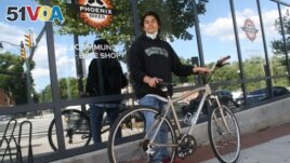 Anthony Jimenez-Galindo with his finished bike outside the Phoenix Bikes store. (Dan Novak/VOA)