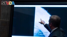 Deputy Director of Naval Intelligence Scott Bray points to a video display of a UAP during a hearing of the House committee hearing on Unidentified Aerial Phenomena, on Capitol Hill, Tuesday, May 17, 2022, in Washington. (AP Photo/Alex Brandon)

