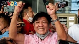 Philippine presidential candidate Ferdinand 'Bongbong' Marcos Jr., son of late dictator Ferdinand Marcos, greets his supporters at his headquarters in Mandaluyong City, Metro Manila, May 11, 2022. 