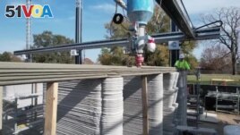An enormous printer weighing more than 12 tons is creates what is believed to be the first 3D-printed, two-story home in the United States, January 12, 2023. (Reuters from video)
