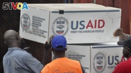 American aid goods are loaded onto a truck after it arrived by airplane, to be used in the fight against the Ebola virus spreading in the city of Monrovia, Liberia, Aug. 24, 2014.