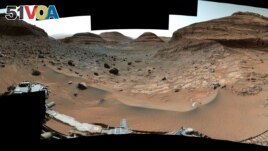 NASA's Curiosity Mars rover used its Mast Camera, or Mastcam, to capture this panorama while driving toward the center of this scene, an area that forms the narrow 