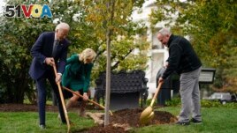 President Joe Biden, first lady Jill Biden and Dale Haney, the chief White House groundskeeper, right, participate in a tree planting ceremony on the South Lawn of the White House, Monday, Oct. 24, 2022, in Washington. (AP Photo/Evan Vucci)