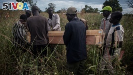 Pallbearers at the border of South Sudan and Uganda carry the casket containing the remains of Duku Evans, a civilian killed November 3 amid fighting between government troops and rebels in Logo displaced persons camp in Kajo Keji, South Sudan, Nov. 5, 20