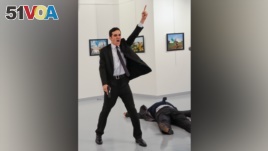 A man gestures after shooting Andrei Karlov