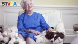 First Lady Barbara Bush poses with her dog Millie in 1990. (AP Photo/Doug Mills)