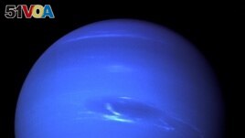 The Great Dark Spot, a storm in the atmosphere and the bright, light-blue smudge of clouds that accompanies the storm is seen on the planet Neptune, taken by the NASA spacecraft Voyager 2 less than five days before its closest approach of the planet on 