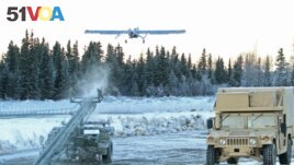 In this Jan. 30, 2014 photo, an unmanned aircraft flies at Joint Base Elmendorf-Richardson in Anchorage, Alaska. U.S. military bases in the Arctic and sub-Arctic are not taking steps against climate change, the Pentagon's watchdog office said recently. (AP Photo/Dan Joling, File)