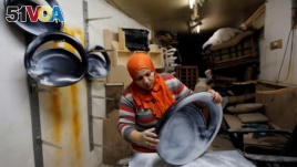 FILE - Carpenter-designer Asmaa Megahed, 30, is pictured in her workshop in Cairo.