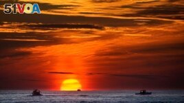 FILE - Lobster fishermen work at sunrise in the Atlantic Ocean, Sept. 8, 2022, off of Kennebunkport, Maine. Scientists, lawyers and government officials are debating deep sea mining at a conference this week. (AP Photo/Robert F. Bukaty, File)