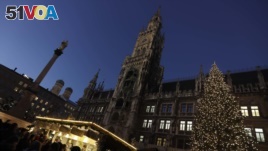Visitors take a stroll at the Christmas market in front of the town hall at the Marienplatz square in Munich, Germany, Dec. 8, 2016. A strong police presence was felt at the square following the Berlin market attack.