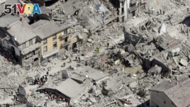 Rescuers search amid rubble following an earthquake in Amatrice Italy, Wednesday, Aug. 24, 2016. 