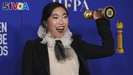 Awkwafina poses in the press room with the award for best performance by an actress in a motion picture, musical or comedy for 