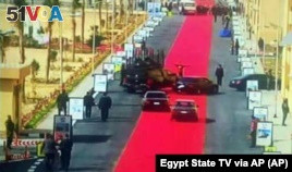Egyptian President Abdel-Fattah el-Sisi's motorcade drives on a red carpet during a trip to open social housing projects in a suburb of Cairo, Egypt. 