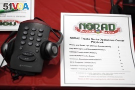 A playbook sits next to a telephone set up in the NORAD Tracks Santa center at Peterson Air Force Base, Monday, Dec. 23, 2019, in Colorado Springs, Colo. More than 1,500 volunteers will handle an estimated 140,000 telephone calls from children and their parents who will be checking on the wherabouts of Santa Claus on Christmas Eve. (AP Photo/David Zalubowski)