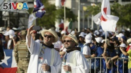 Two priests pose for a selfie before the opening ceremony and mass of World Youth Day Panama 2019, in Panama City, Tuesday, Jan. 22, 2019. (AP Photo/Arnulfo Franco)