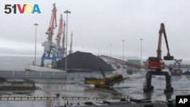 Coal brought from Siberia is ready to be loaded onto a ship bound for China in the North Korean special economic zone of Rason.