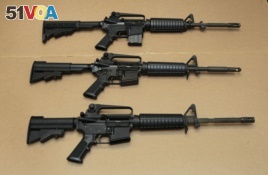 FILE -- Three variations of the AR-15 assault rifle are displayed in Sacramento, Calif.