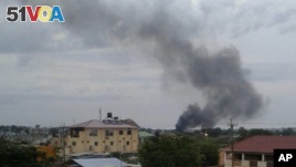 In this photo taken Sunday, July 10, 2016, black smoke is seen rising above the capital Juba, in South Sudan. 