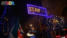 Anti-Brexit demonstrators stand outside the Houses of Parliament in London, Sept. 9, 2019.