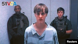 Dylann Storm Roof appears by closed-circuit television at his bond hearing in Charleston, South Carolina June 19, 2015 in a still image from video. A 21-year-old white man has been charged with nine counts of murder in connection with an attack on a histo