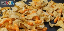 A mixture of salty snacks and chips is shown left on a table in Pittsburgh's Market Square on Tuesday, Feb. 7, 2012