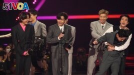 BTS accepts the award for artist of the year at the American Music Awards on Sunday, Nov. 21, 2021 at Microsoft Theater in Los Angeles. (AP Photo/Chris Pizzello)