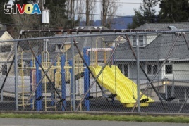 A playground at Lowell Elementary School in Tacoma, Washington sits empty after school closed because of the coronavirus. Parents are deciding how to talk with their children about the virus.