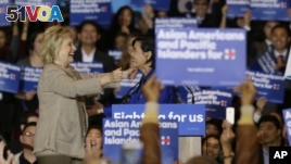 Democratic presidential candidate Hillary Clinton, left, is welcomed by Rep. Judy Chu, D-Calif., before addressing Asian American and Pacific Islander supporters in San Gabriel, Calif., Thursday, Jan. 7, 2016.  (AP Photo/Damian Dovarganes)