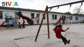 FILE - Children play in a playground at the camp for migrants and refugees in Friedland, Germany, April 4, 2016. (REUTERS/Kai Pfaffenbach)