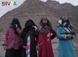 In this March 30, 2019 photo, the first female Bedouin guides, from right, Selima, Umm Yasser, Umm Soliman, and Aicha, pose for a photograph in Wadi Sahw, Abu Zenima, in South Sinai, Egypt. Four Bedouin women are for the first time leading tours in Egypt