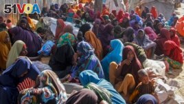 FILE - Somalis who fled drought-stricken areas sit at a makeshift camp on the outskirts of the capital Mogadishu, Somalia on Feb. 4, 2022. (AP Photo/Farah Abdi Warsameh, File)