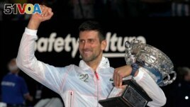 Novak Djokovic of Serbia gestures as he holds the Norman Brookes Challenge Cup after defeating Stefanos Tsitsipas of Greece in the men's singles final at the Australian Open tennis championship in Melbourne, Australia, Sunday, Jan. 29, 2023. (AP Photo/Dita Alangkara)