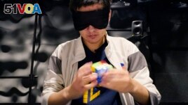University of Michigan student Stanley Chapel solves a Rubik's Cube while blindfolded, Wednesday, Nov. 23, 2022, in Ann Arbor, Mich. (AP Photo/Carlos Osorio)