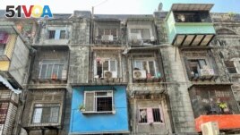 Under a redevelopment project, high rise buildings will replace these damaged, century-old tenements called BDD Chawls in the heart of Mumbai and give the residents new, larger homes. (Anjana Pasricha/VOA)