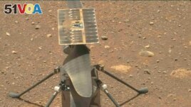 The Ingenuity Mars helicopter's carbon fiber blades can be seen in this image, taken from video that was captured by the Mastcam-Z instrument aboard NASA's Perseverance Mars rover on April 8, 2021. (Image Credit: NASA/JPL-Caltech/ASU)