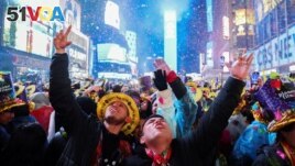 FILE - People celebrate as confetti flies around the countdown clock during the first public New Year's event at Times Square, in the Manhattan borough of New York City, Jan. 1, 2023. (REUTERS/Andrew Kelly)