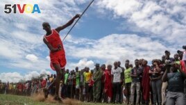 A Maasai man throws a javelin as he competes in the Maasai Olympics in Kimana Sanctuary, southern Kenya Saturday, Dec. 10, 2022. (AP Photo/Brian Inganga)