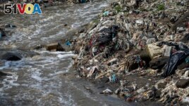 Plastic bottles and waste float pollute the Las Vacas river in Chinautla, near Guatemala City, Wednesday, June 8, 2022.