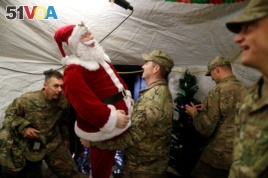 U.S. soldiers enjoy a Christmas dinner at an army base in Karamless town, east of Mosul, December 25, 2016. REUTERS/Ammar Awad