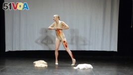 Ksenia Vidyaykina performs as a 1920's era strip tease dancer who takes off her cloths, and then her skin in a portion of 