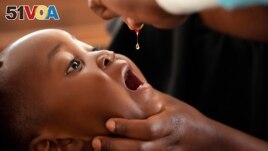 A baby recieves a vitamin booster during a measles vaccination drive at a clinic in Harare, Zimbabwe, Thursday, Sept. 15, 2022. (AP Photo/Tsvangirayi Mukwazhi)