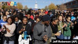 Students dance following University of Missouri System President Tim Wolfe's resignation announcement Monday, Nov. 9, 2015, at the school in Columbia, Mo.