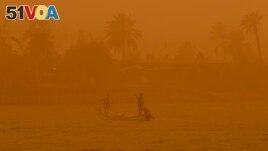 FILE - Fishermen navigate on the Shatt al-Arab waterway during a sandstorm in Basra, Iraq, May 23, 2022. This year's annual U.N. climate change conference, known as COP27, is being held in Egypt in November, throwing a spotlight on the region. (AP Photo/Nabil al-Jurani)