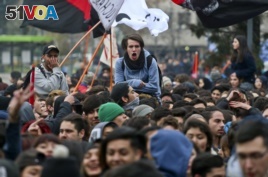 Youths take part in a march demanding the government overhaul the education funding system that would include canceling student loan debt, in Santiago, Chile, Wednesday, June 21, 2017.