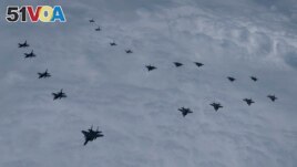 In this photo provided by South Korea Defense Ministry, US and South Korean fighter jets fly in formation during a joint drill, June 7, 2022. (South Korean Defense Ministry via AP)